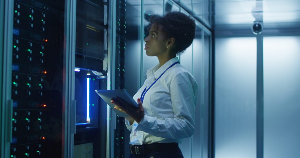 female IT engineer working on server rack