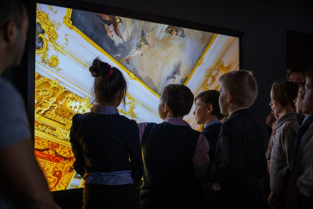 children using interactive white board in class