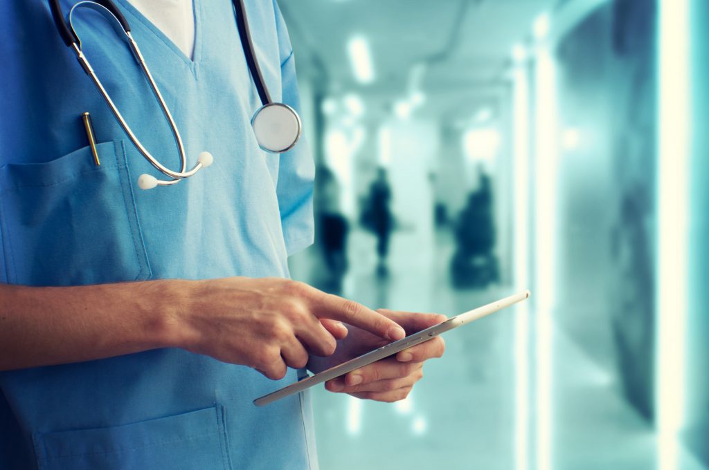 doctor on a tablet in a hallway