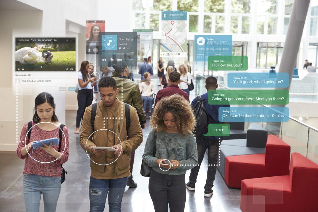 millenials using social media walking through university