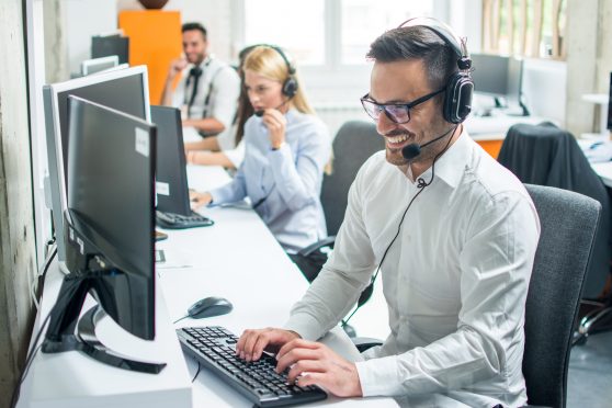 technical support on telephone to client smiling