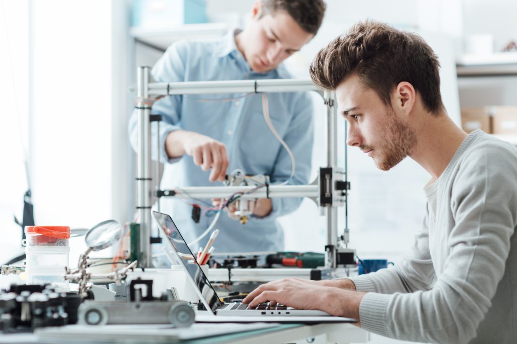 students in a lab working on a laptop