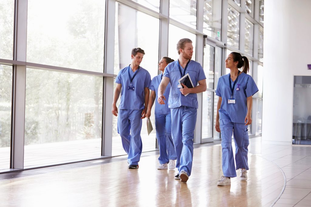 group of nurses walking through a hospital